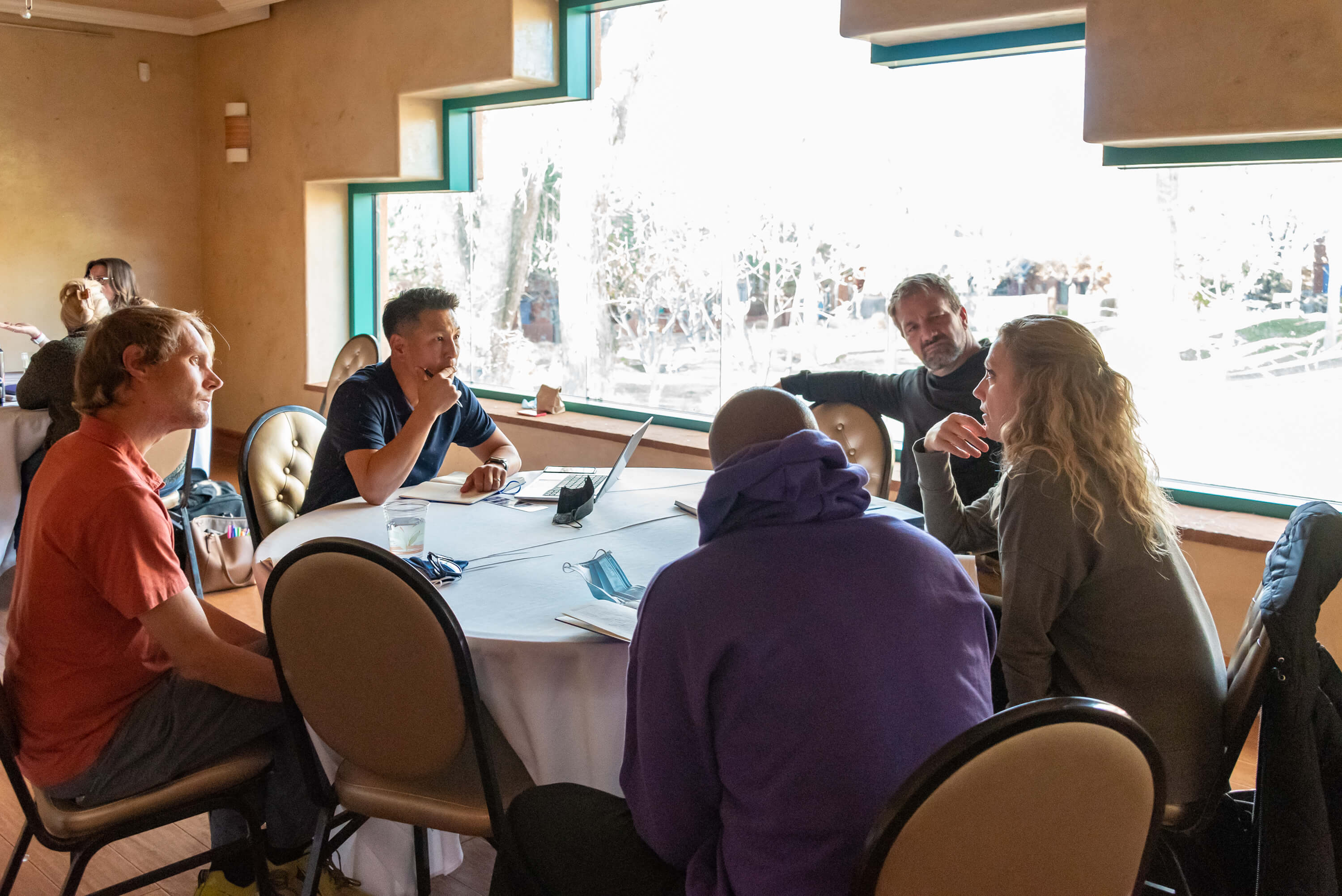 Educational leaders in focused discussion, representing mentorship model over conferences for school administrators